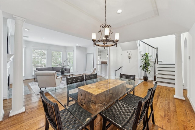 2007 Indiana St, Houston, TX 77019 - dining space featuring ornate columns, light wood finished floors, recessed lighting, and stairs