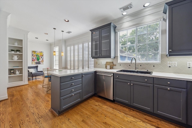 2007 Indiana St, Houston, TX 77019 - kitchen featuring a sink, dishwasher, gray cabinets, a peninsula, and ornamental molding