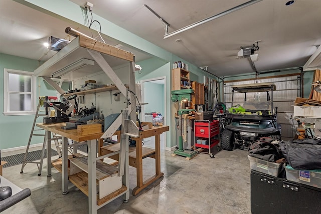 10910 Maddys Ct, Montgomery, TX 77316 - garage featuring a garage door opener, a workshop area, and baseboards
