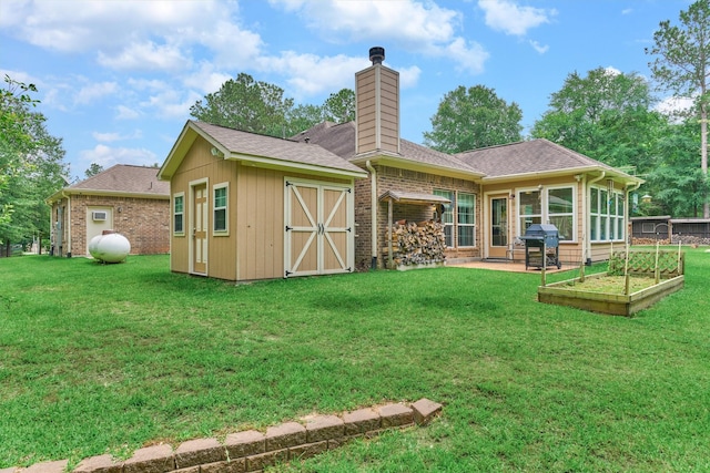 10910 Maddys Ct, Montgomery, TX 77316 - rear view of property featuring a chimney, brick siding, a lawn, and a vegetable garden