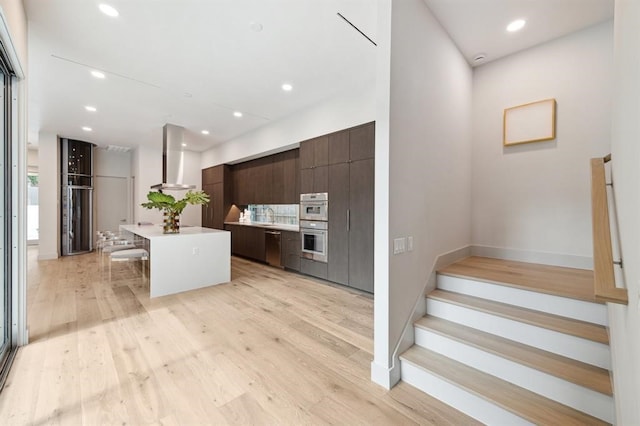 2129 Quenby St, Houston, TX 77005 - kitchen featuring dark brown cabinetry, modern cabinets, a kitchen island, stainless steel appliances, and a kitchen breakfast bar