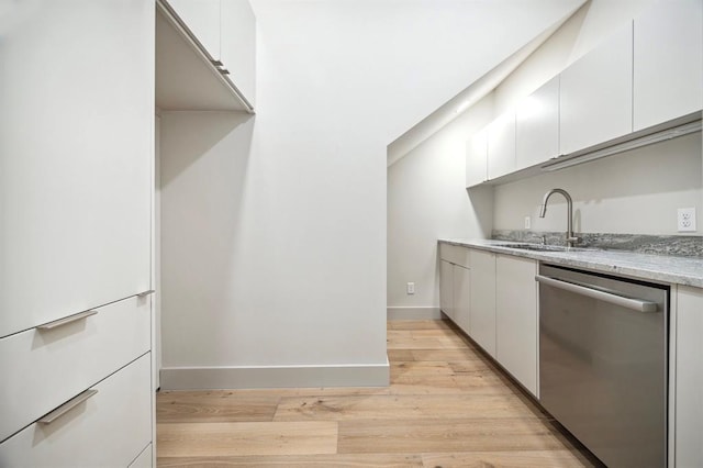 2129 Quenby St, Houston, TX 77005 - kitchen featuring dishwasher, a sink, light wood finished floors, white cabinets, and light stone counters