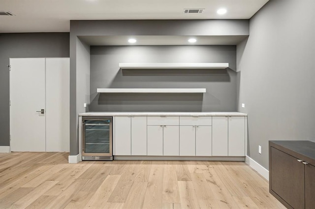 2129 Quenby St, Houston, TX 77005 - indoor dry bar featuring wine cooler, light wood finished floors, baseboards, and recessed lighting