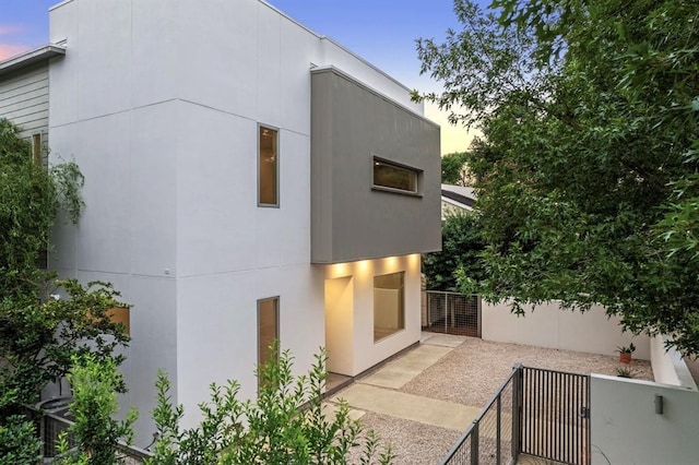 2129 Quenby St, Houston, TX 77005 - back of property at dusk with stucco siding