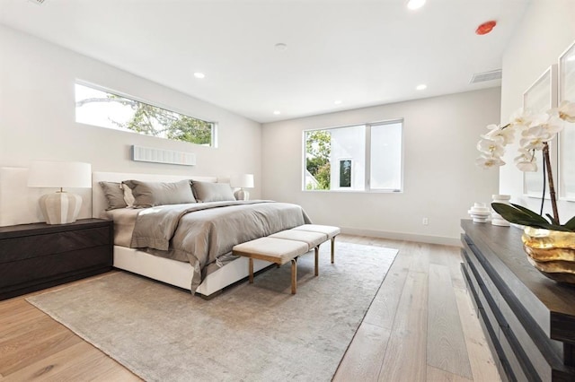 2129 Quenby St, Houston, TX 77005 - bedroom with light wood-type flooring, multiple windows, recessed lighting, and baseboards