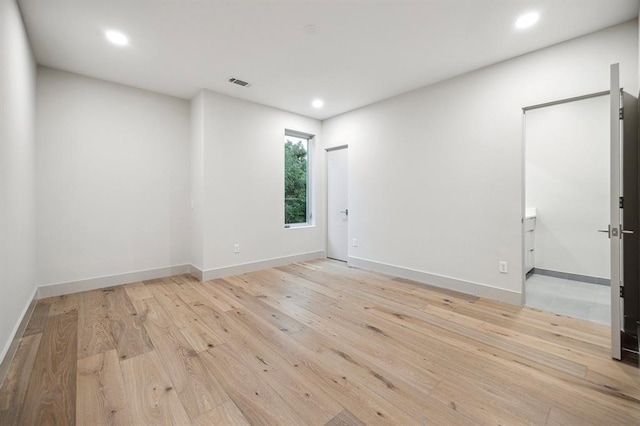 2129 Quenby St, Houston, TX 77005 - spare room featuring light wood-type flooring, recessed lighting, and baseboards