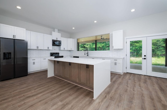 354 Peach Point Ln, Trinity, TX 75862 - kitchen featuring refrigerator with ice dispenser, a kitchen island, white cabinetry, a sink, and recessed lighting
