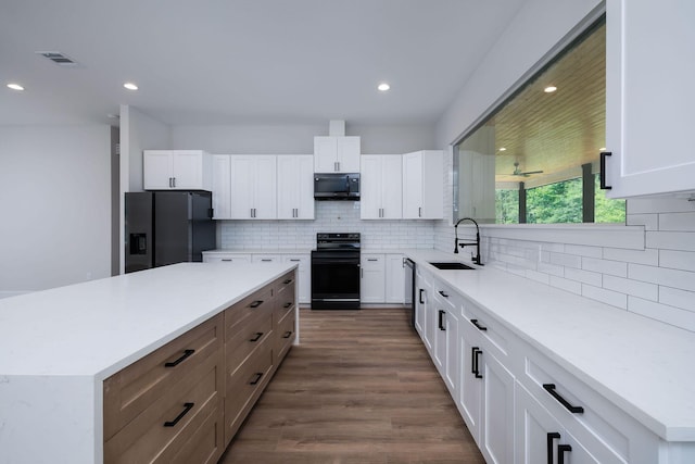 354 Peach Point Ln, Trinity, TX 75862 - kitchen with black appliances, a sink, white cabinetry, decorative backsplash, and recessed lighting