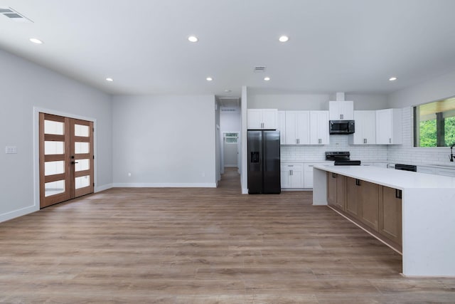 354 Peach Point Ln, Trinity, TX 75862 - kitchen with appliances with stainless steel finishes, light countertops, white cabinetry, recessed lighting, and backsplash