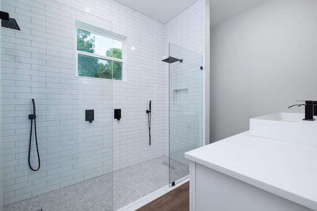 354 Peach Point Ln, Trinity, TX 75862 - bathroom featuring vanity, tiled shower, and wood finished floors