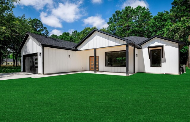354 Peach Point Ln, Trinity, TX 75862 - modern inspired farmhouse with a front yard, a shingled roof, board and batten siding, and an attached garage