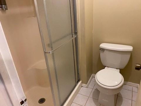 6662 Canyon Way Dr, Houston, TX 77086 - bathroom featuring a shower stall, tile patterned floors, toilet, and baseboards