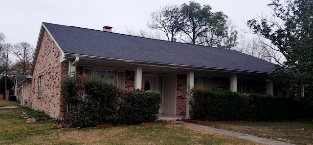 6662 Canyon Way Dr, Houston, TX 77086 - view of front of house with a shingled roof, brick siding, and a chimney