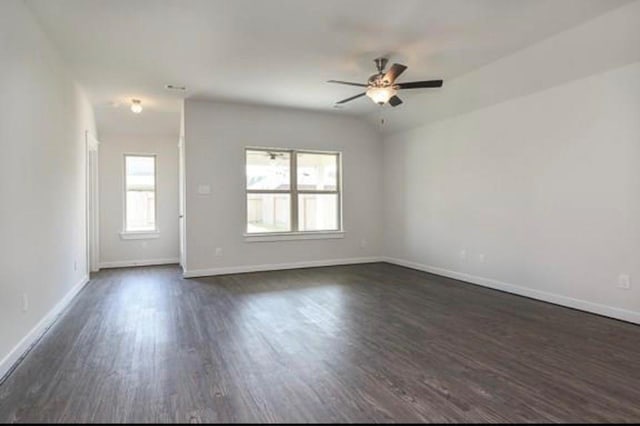 2726 Little Caney Way, Conroe, TX 77301 - unfurnished living room featuring dark wood-style flooring, a ceiling fan, and baseboards
