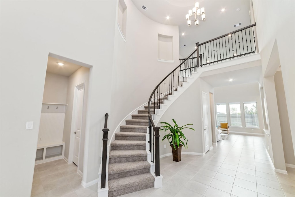 11319 Cosmopolitan Dr, Cypress, TX 77433 - stairs with a high ceiling, tile patterned flooring, a chandelier, baseboards, and recessed lighting