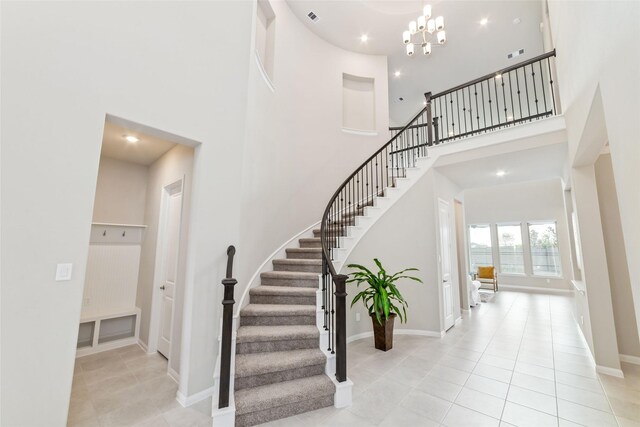 11319 Cosmopolitan Dr, Cypress, TX 77433 - stairs with a high ceiling, tile patterned flooring, a chandelier, baseboards, and recessed lighting