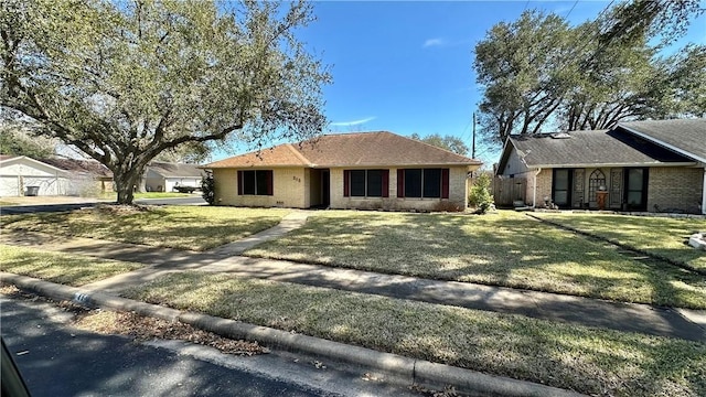 213 Yuma Dr, Victoria, TX 77904 - single story home featuring brick siding, a front yard, and roof with shingles