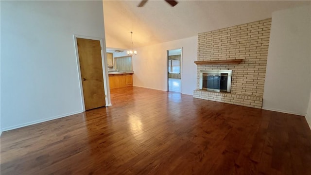 213 Yuma Dr, Victoria, TX 77904 - unfurnished living room with a ceiling fan, dark wood-style flooring, a chandelier, a fireplace, and baseboards