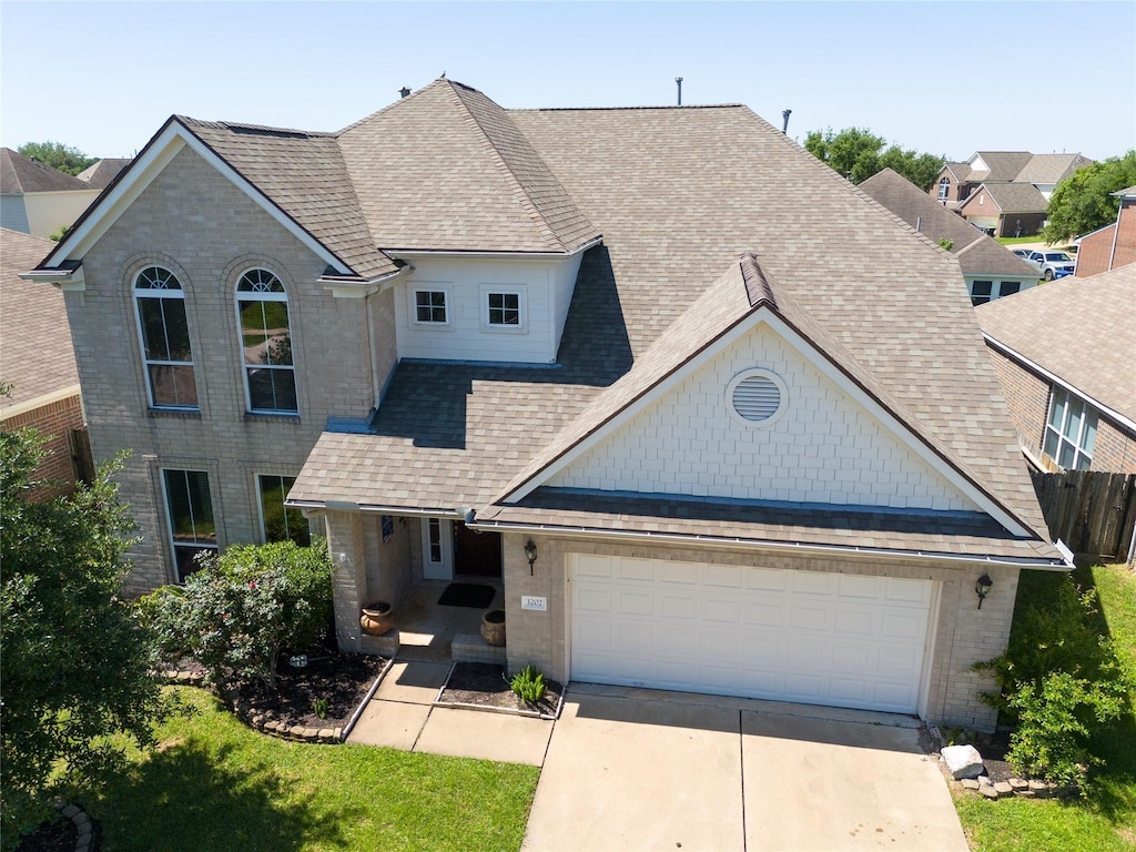 3202 Dogwood Knoll Trl, Rosenberg, TX 77471 - traditional-style home with driveway, brick siding, a shingled roof, and an attached garage