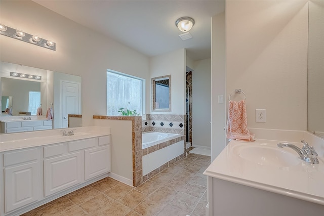 20810 Mansfield Bay Ln, Richmond, TX 77407 - bathroom featuring a bath, a shower stall, and two vanities