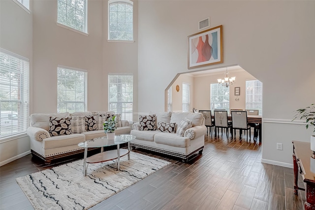 20810 Mansfield Bay Ln, Richmond, TX 77407 - living room featuring a chandelier, a towering ceiling, dark wood-style floors, and baseboards