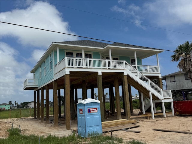 806 93rd St, Galveston, TX 77554 - coastal home with a shingled roof, a carport, and stairway