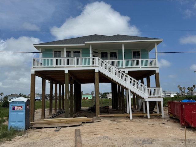 806 93rd St, Galveston, TX 77554 - view of front facade featuring a shingled roof, stairs, and a porch
