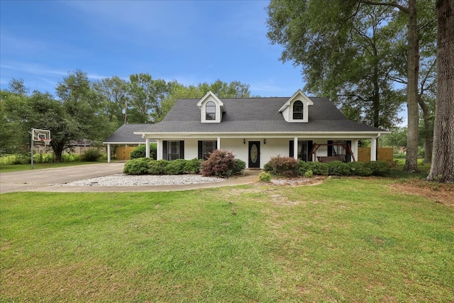 504 County Road 763 N, Buna, TX 77612 - view of front of house featuring a porch, driveway, and a front yard