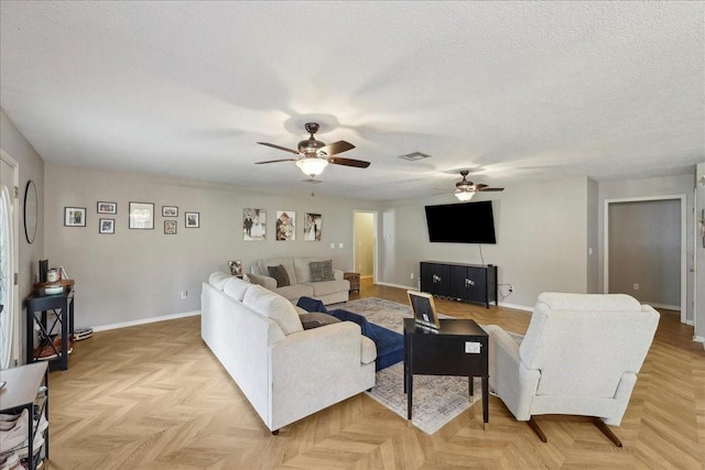 504 County Road 763 N, Buna, TX 77612 - living room featuring ceiling fan, baseboards, and a textured ceiling