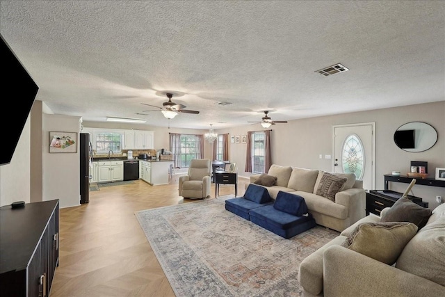 504 County Road 763 N, Buna, TX 77612 - living area featuring ceiling fan, a chandelier, and a textured ceiling