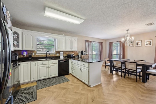 504 County Road 763 N, Buna, TX 77612 - kitchen with dishwasher, a sink, a peninsula, a chandelier, and dark countertops