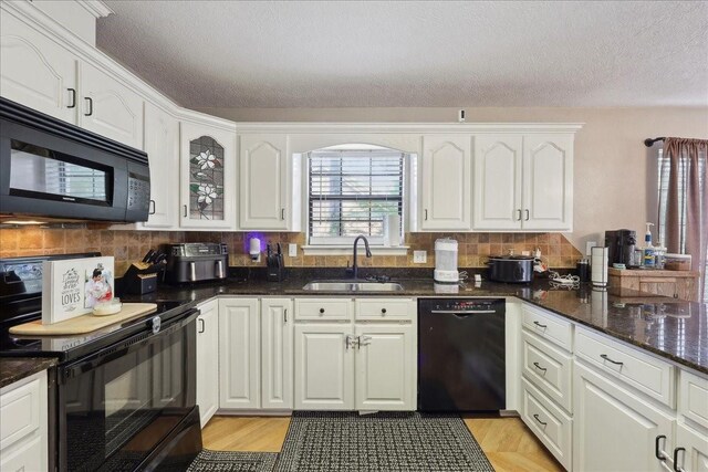 504 County Road 763 N, Buna, TX 77612 - kitchen featuring black appliances, a sink, a textured ceiling, decorative backsplash, and white cabinetry