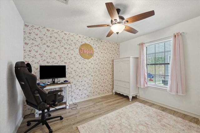 504 County Road 763 N, Buna, TX 77612 - office area with wallpapered walls, wood finished floors, a ceiling fan, baseboards, and a textured ceiling