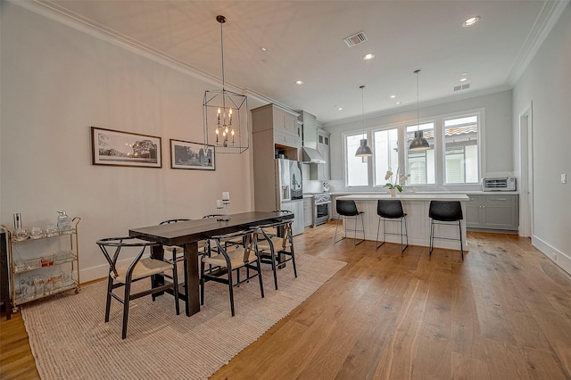5213 Feagan St Unit H, Houston, TX 77007 - dining space featuring crown molding, light wood-style floors, recessed lighting, baseboards, and a chandelier