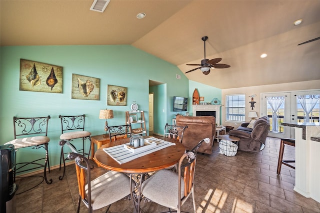 3190 Fm-2031, Matagorda, TX 77414 - dining area featuring a ceiling fan, lofted ceiling, a tile fireplace, recessed lighting, and baseboards