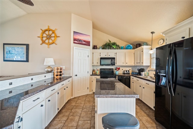 3190 Fm-2031, Matagorda, TX 77414 - kitchen featuring black appliances, lofted ceiling, a kitchen island, tile counters, and hanging light fixtures