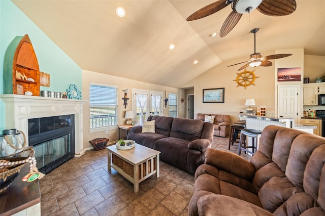 3190 Fm-2031, Matagorda, TX 77414 - living area with vaulted ceiling, a ceiling fan, recessed lighting, a tile fireplace, and baseboards