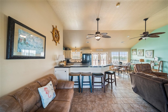 3190 Fm-2031, Matagorda, TX 77414 - living room featuring ceiling fan, lofted ceiling, and light stone finish flooring