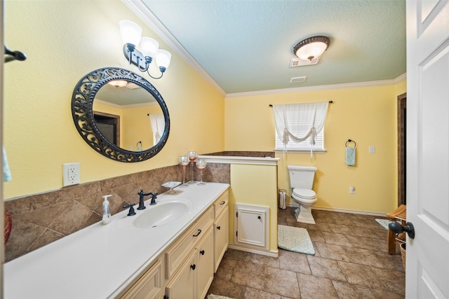 3190 Fm-2031, Matagorda, TX 77414 - bathroom featuring crown molding, toilet, vanity, stone finish flooring, and a textured ceiling
