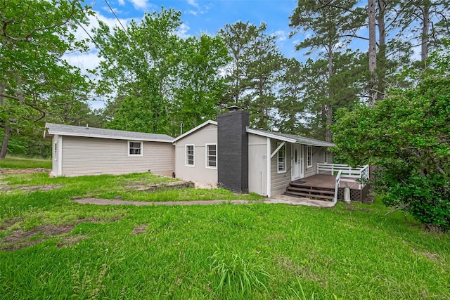 131 Holiday Blvd, Coldspring, TX 77331 - back of house with a deck, a chimney, and a lawn
