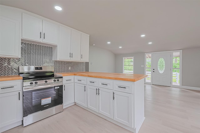 131 Holiday Blvd, Coldspring, TX 77331 - kitchen featuring electric range, wood counters, light wood-style floors, a peninsula, and recessed lighting