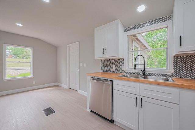 131 Holiday Blvd, Coldspring, TX 77331 - kitchen with stainless steel dishwasher, a sink, wood counters, decorative backsplash, and lofted ceiling