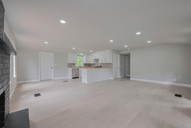 131 Holiday Blvd, Coldspring, TX 77331 - unfurnished living room with a fireplace, recessed lighting, baseboards, and light wood-style flooring