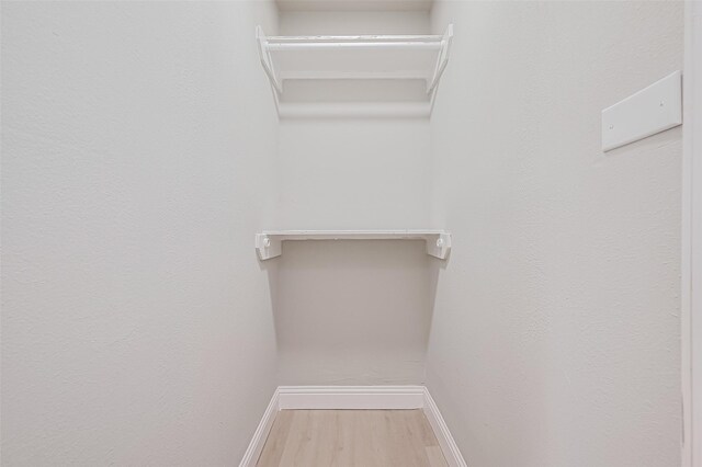 131 Holiday Blvd, Coldspring, TX 77331 - walk in closet featuring wood finished floors