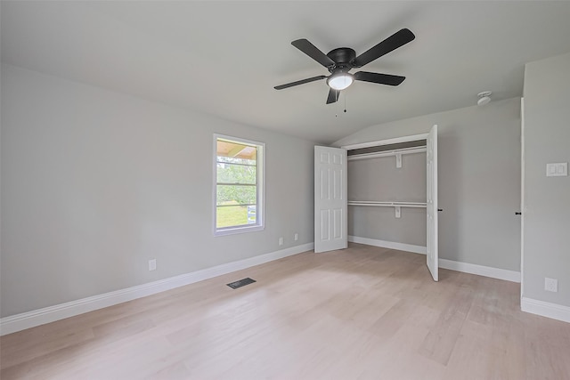 131 Holiday Blvd, Coldspring, TX 77331 - unfurnished bedroom with light wood-style flooring, vaulted ceiling, baseboards, a closet, and a ceiling fan