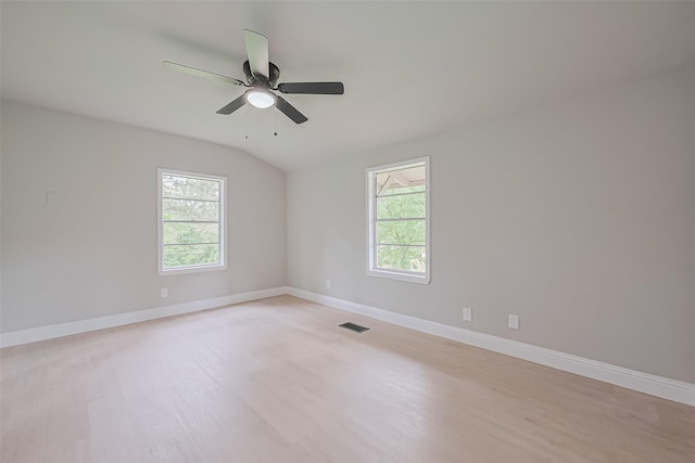 131 Holiday Blvd, Coldspring, TX 77331 - unfurnished room featuring plenty of natural light, ceiling fan, baseboards, light wood-type flooring, and vaulted ceiling