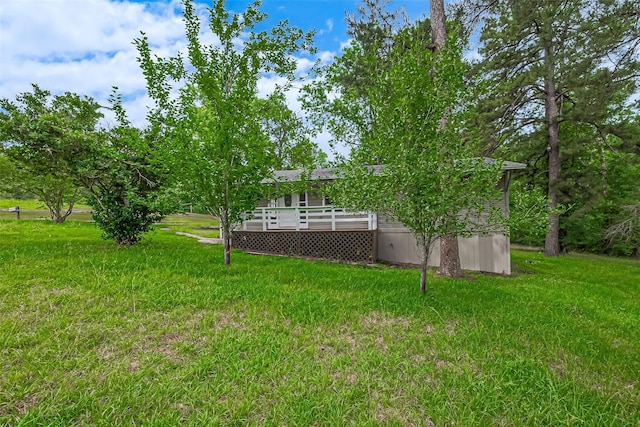 131 Holiday Blvd, Coldspring, TX 77331 - view of green lawn with a deck