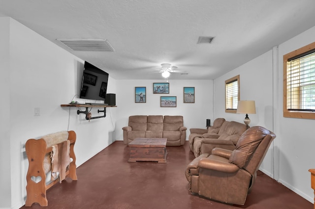 9141 Oak Arbor Dr, Conroe, TX 77384 - living area with a ceiling fan, finished concrete flooring, a textured ceiling, and baseboards