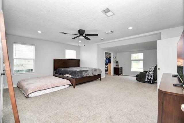 20695 Liberty St, New Caney, TX 77357 - bedroom featuring carpet flooring, recessed lighting, ceiling fan, a textured ceiling, and baseboards
