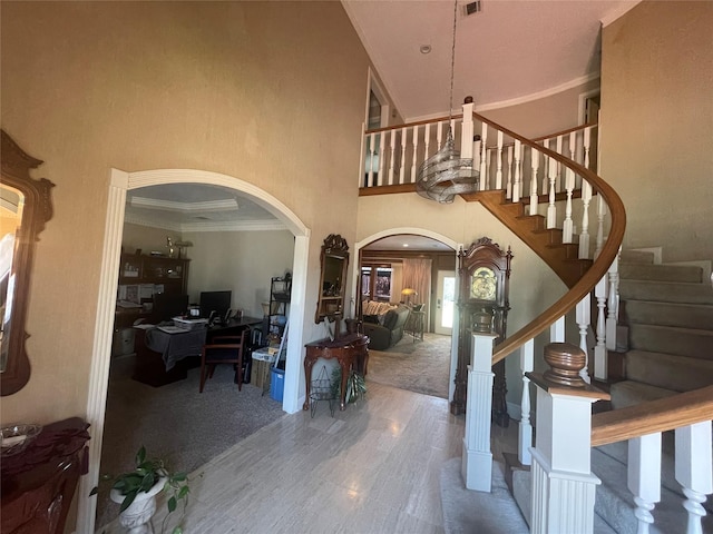 17518 Jackson Pnes, Houston, TX 77090 - foyer entrance with arched walkways, a towering ceiling, stairs, and ornamental molding